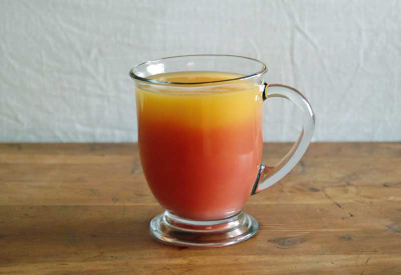 Glass of orange and acai berry juice